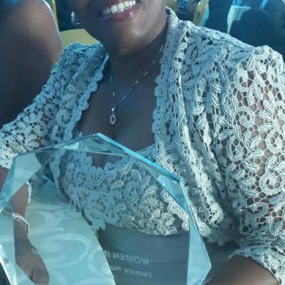 Lilian Keene Poses With The Female Human Rights Lawyer Of The Year 2014 Award